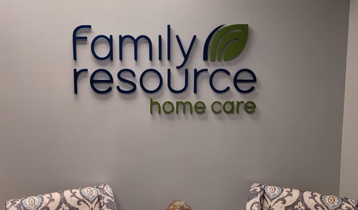 Interior wall features the Family Resource Home Care logo and two patterned chairs.