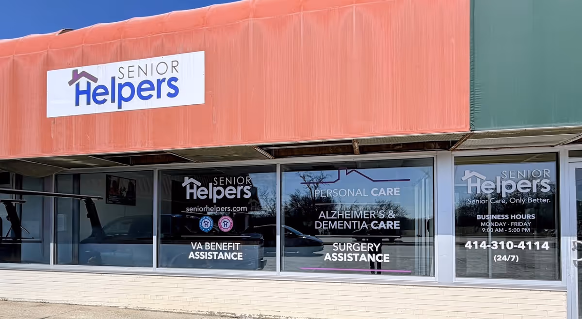 Front of a Senior Helpers storefront with large windows displaying service signs
