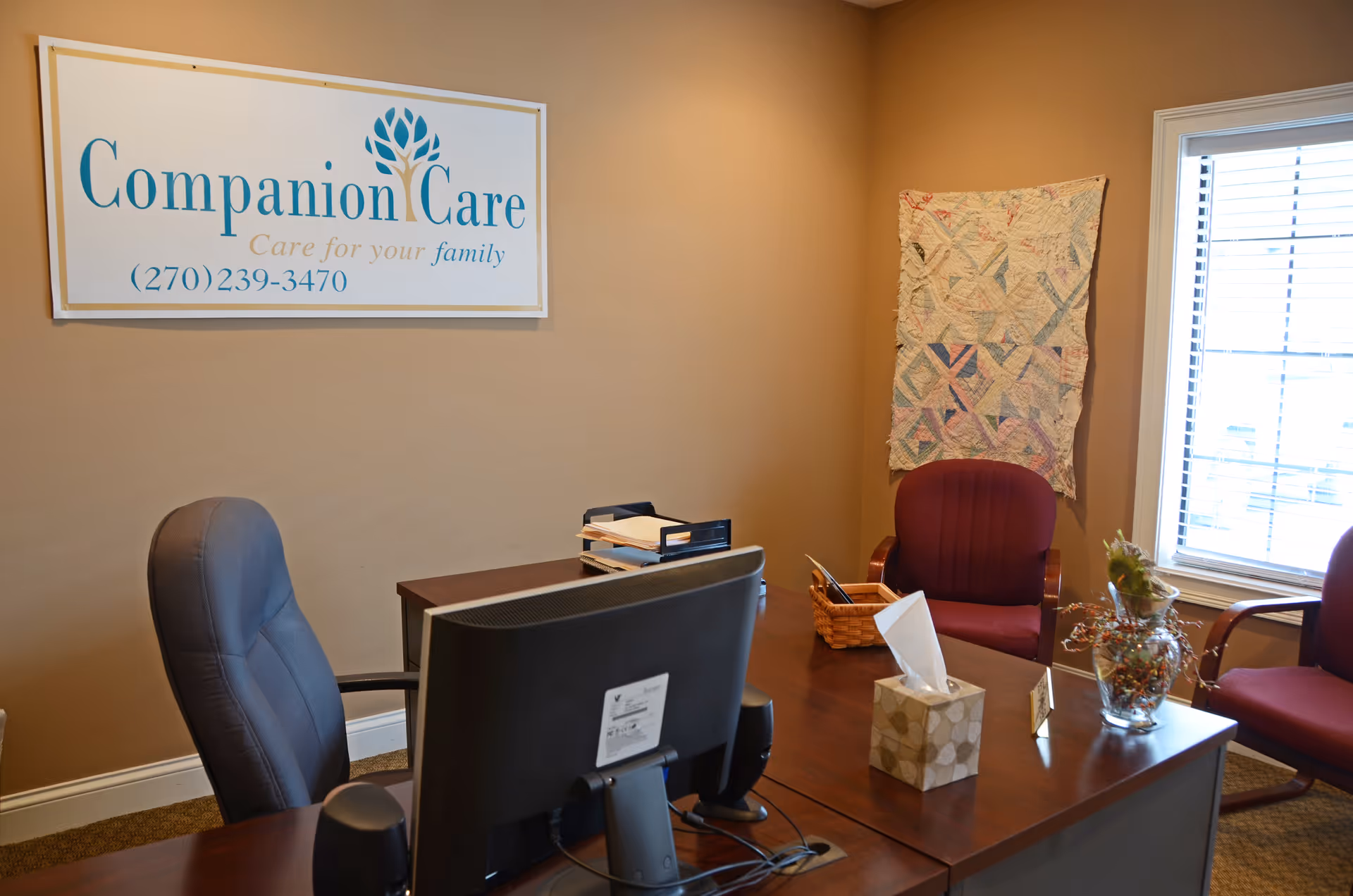 Reception area with desk, Companion Care sign, chairs, and a window.