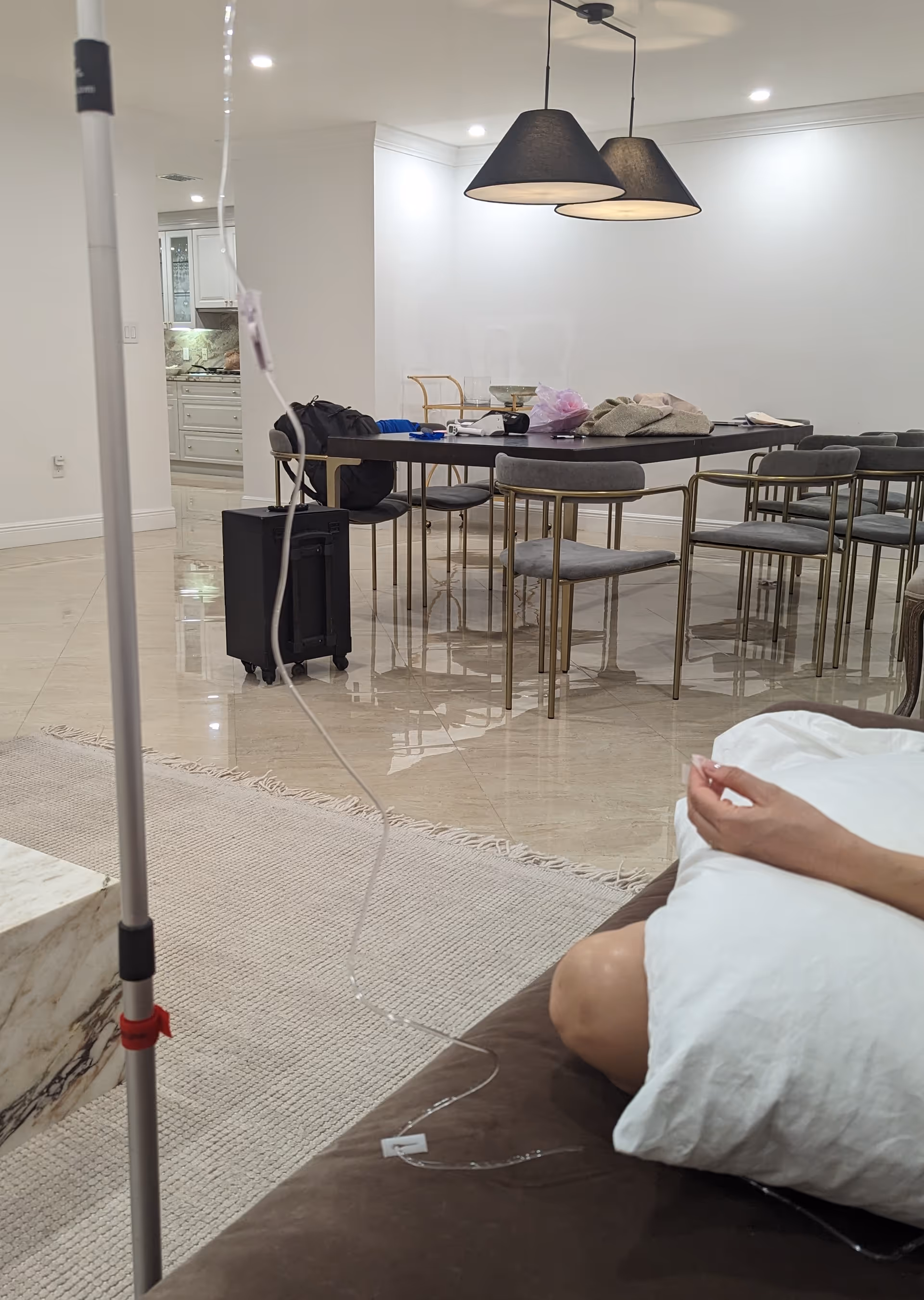 Bright dining area with a table, pendant lamps, and an IV pole nearby.