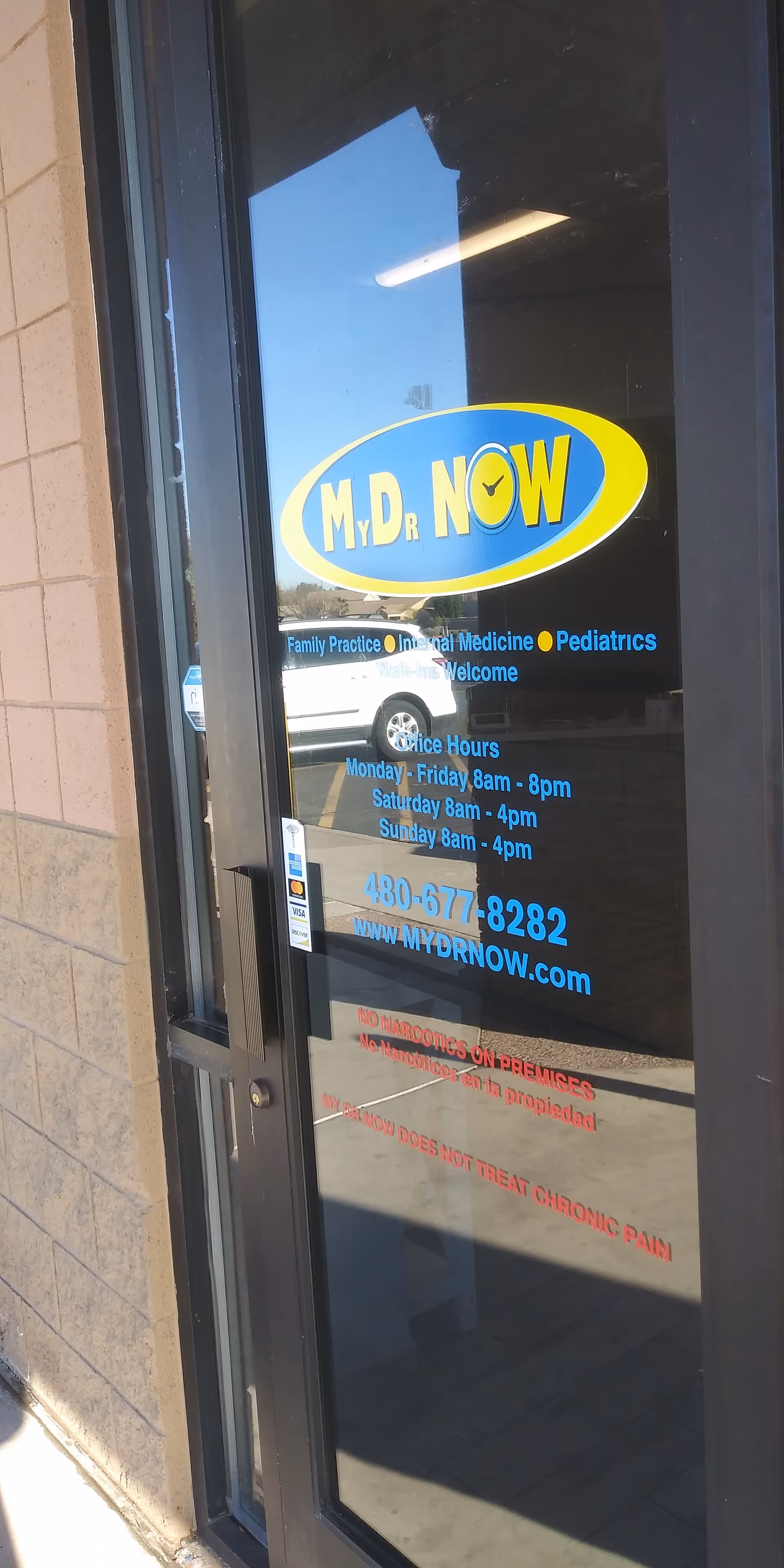 Glass door entrance with MY DR NOW logo and hours