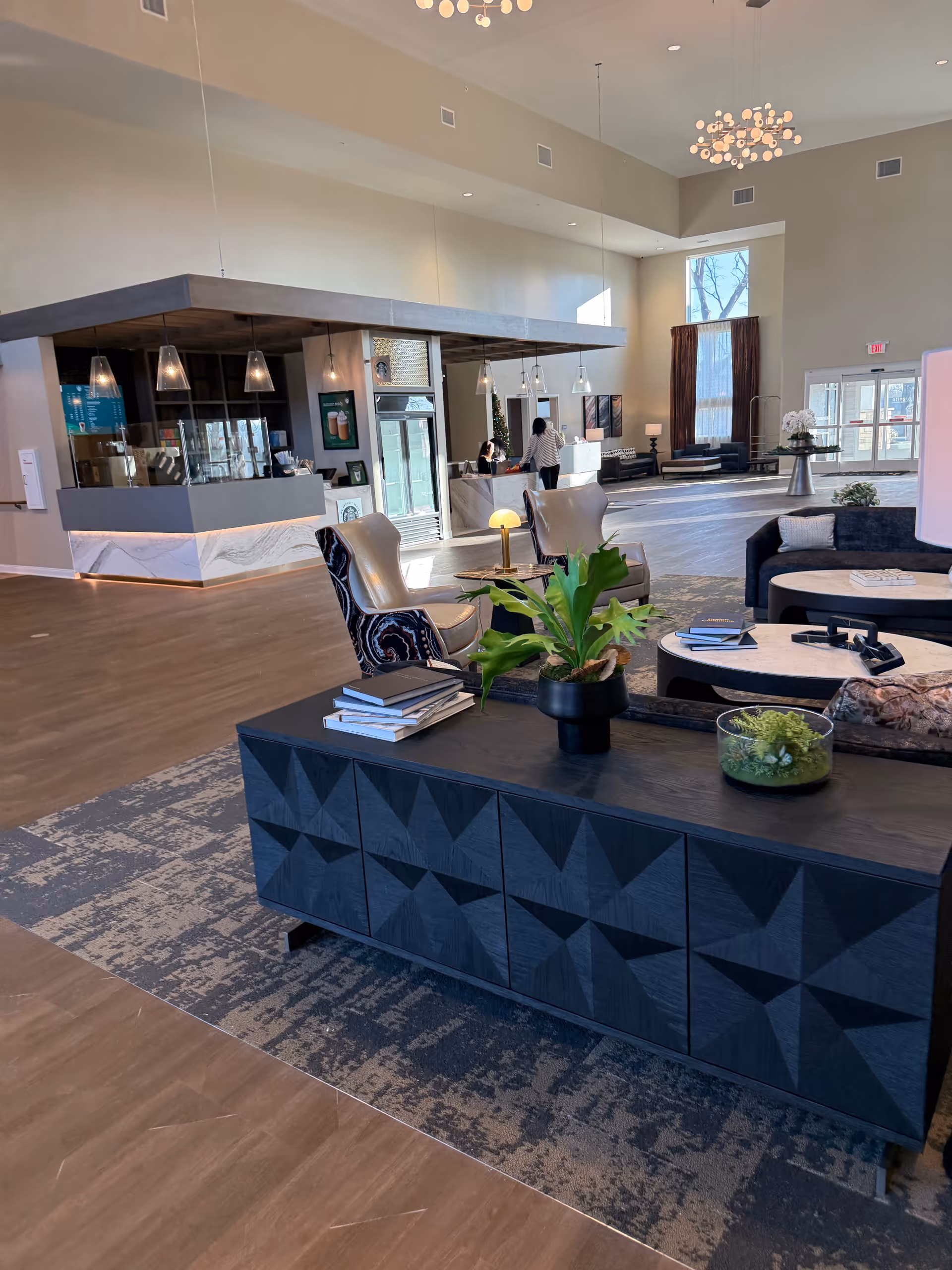 Ignite Medical Resorts lobby with modern seating, a reception desk, and dark geometric cabinet.