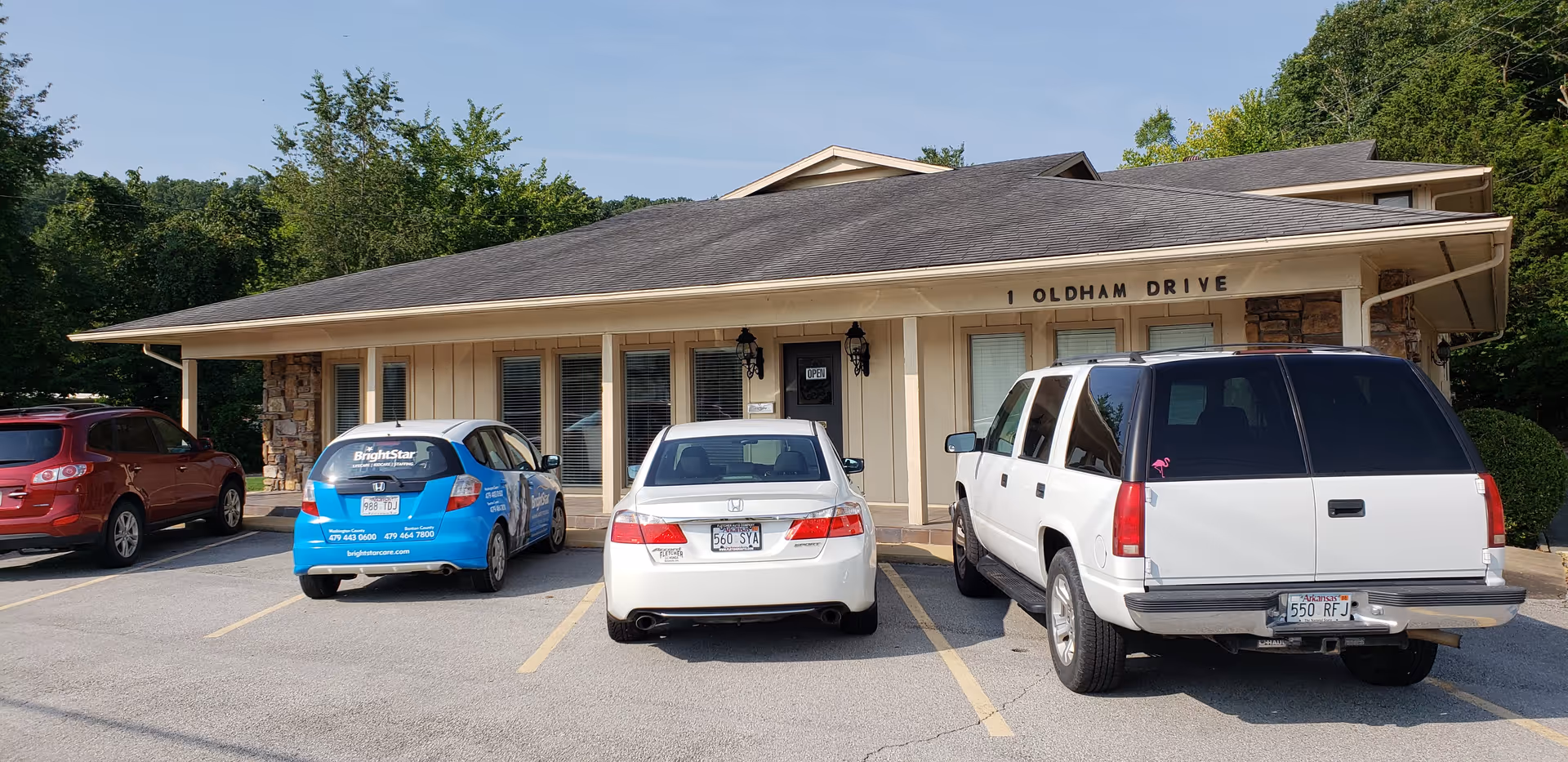 Front exterior of BrightStar Care facility with parked cars in a parking lot.