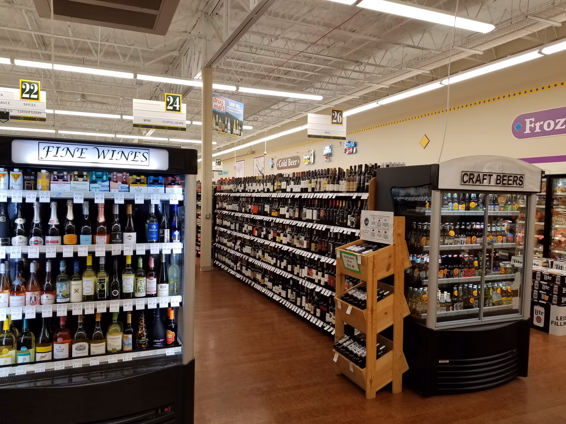 Interior of a Discount Drug Mart store with wine and beer coolers.