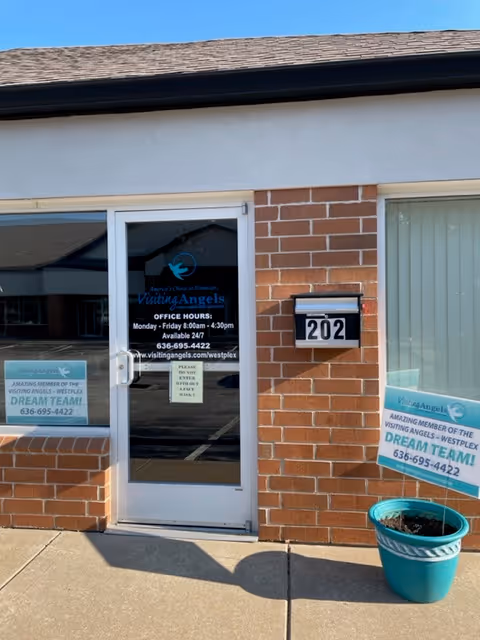 Entrance to Visiting Angels Senior Home Care with glass door and brick front.