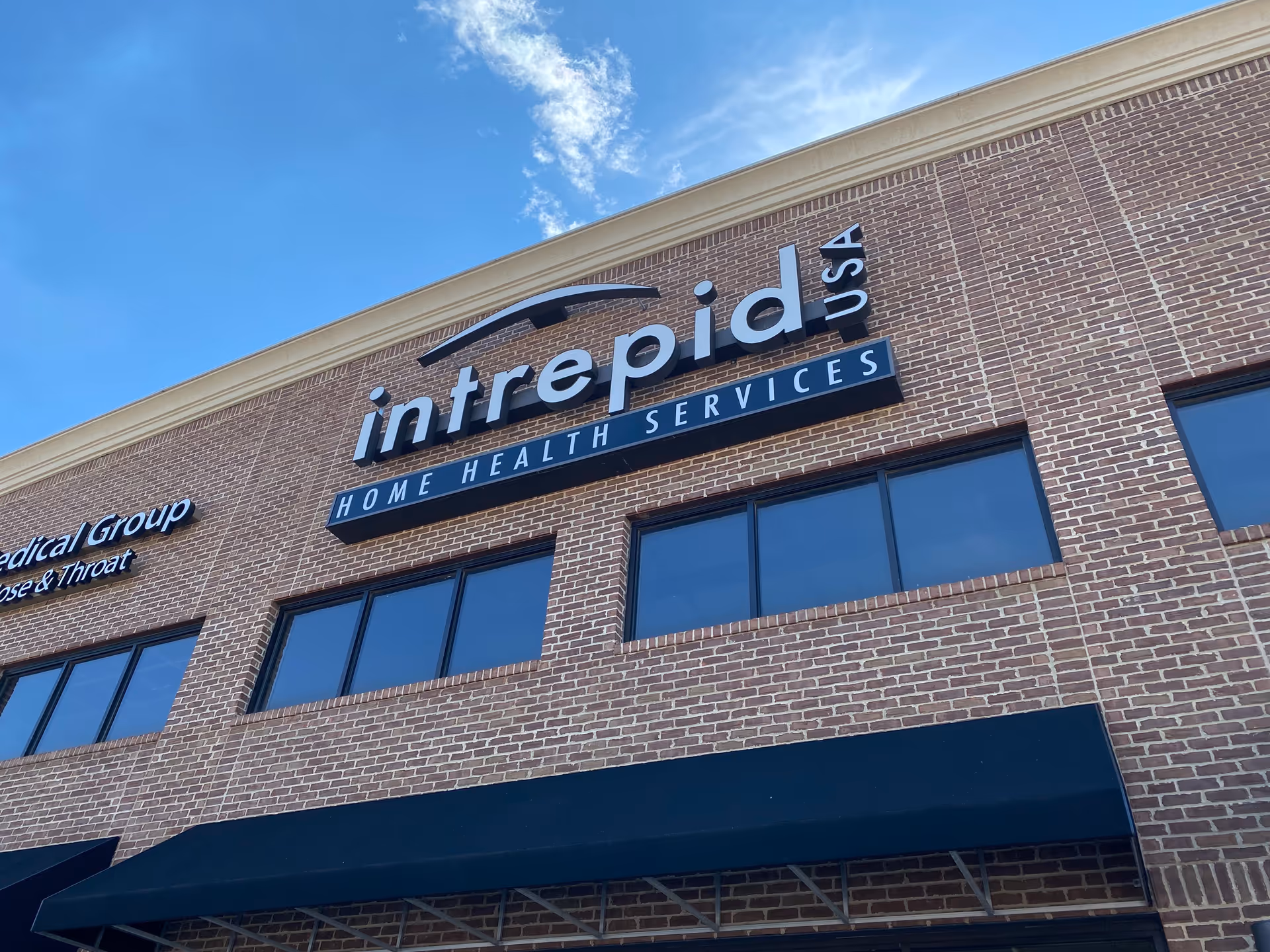 Brick exterior of a building with a large Intrepid USA Home Health Services sign.