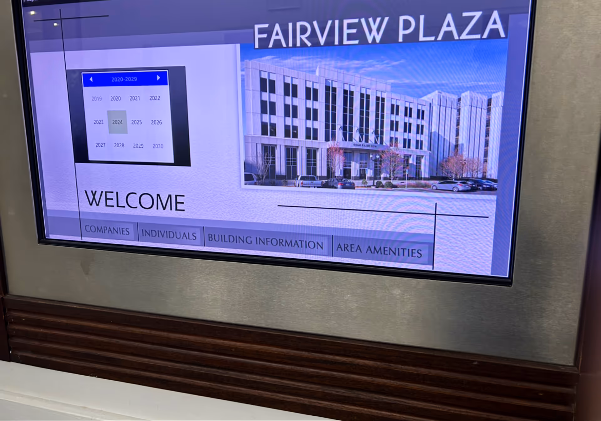 Digital display shows FAIRVIEW PLAZA with a building image and a welcome message.