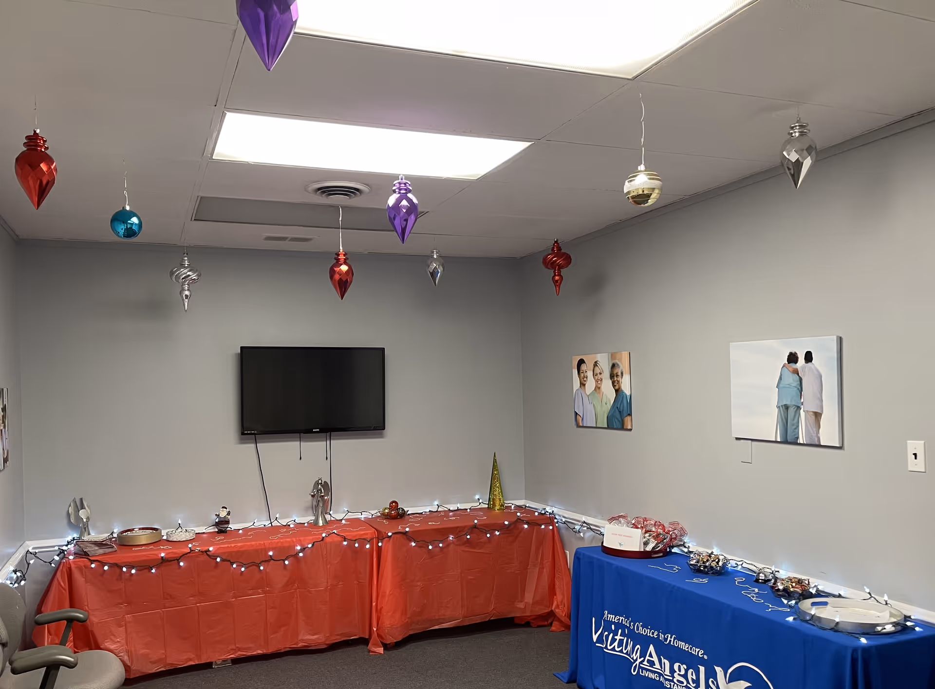 Interior dining room decorated with holiday ornaments and tables for refreshments.