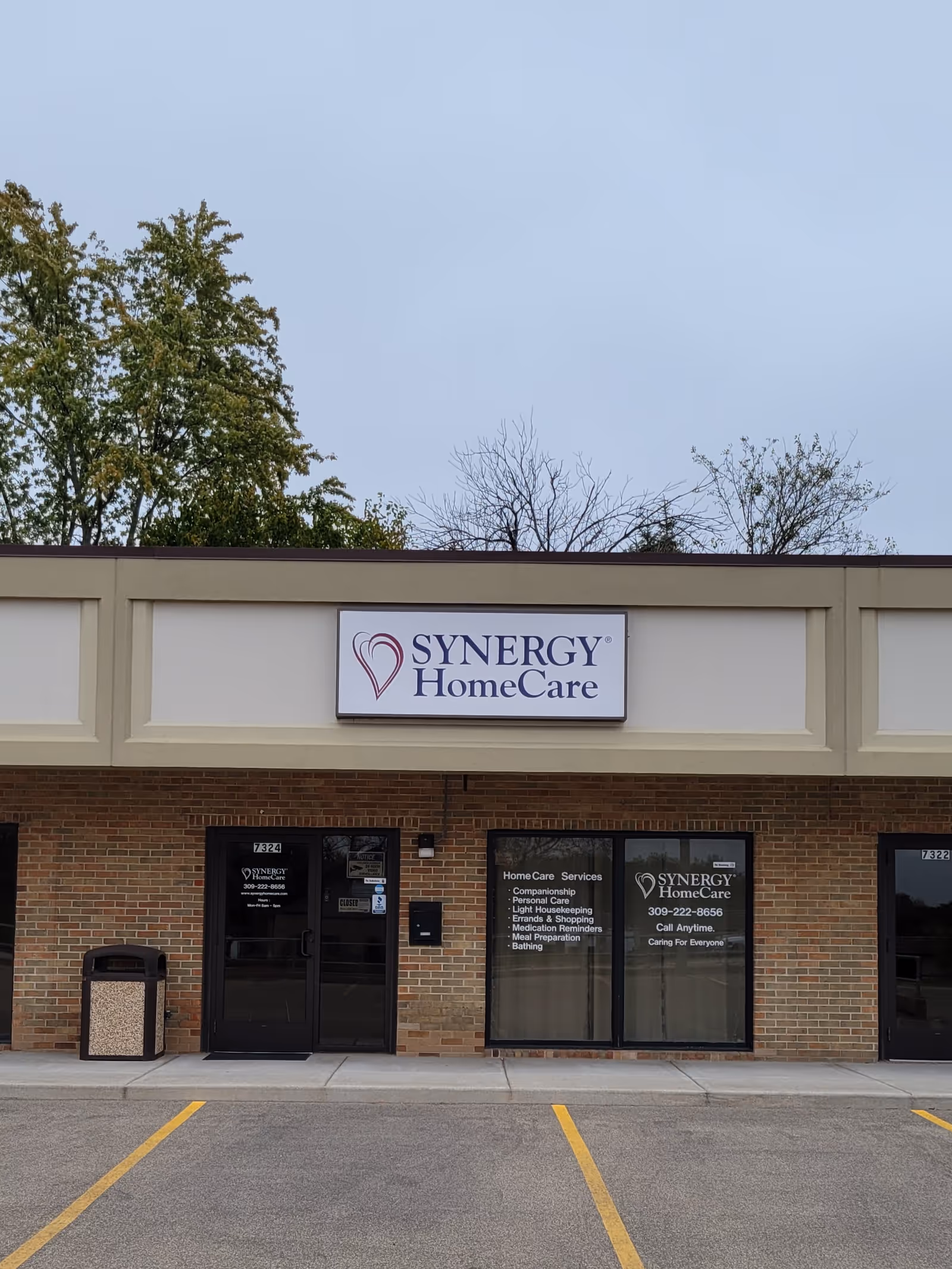 Exterior of a Synergy HomeCare facility with sign and brick facade.