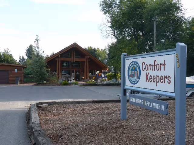 Exterior view of Comfort Keepers facility with a large front sign and entrance.