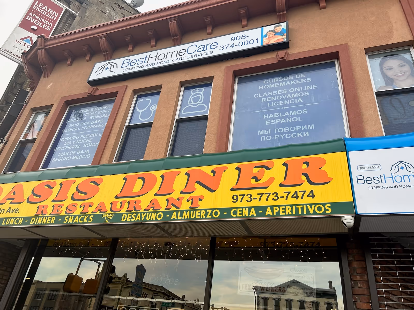 Two-story building with Best Home Care Inc sign above a yellow diner storefront.