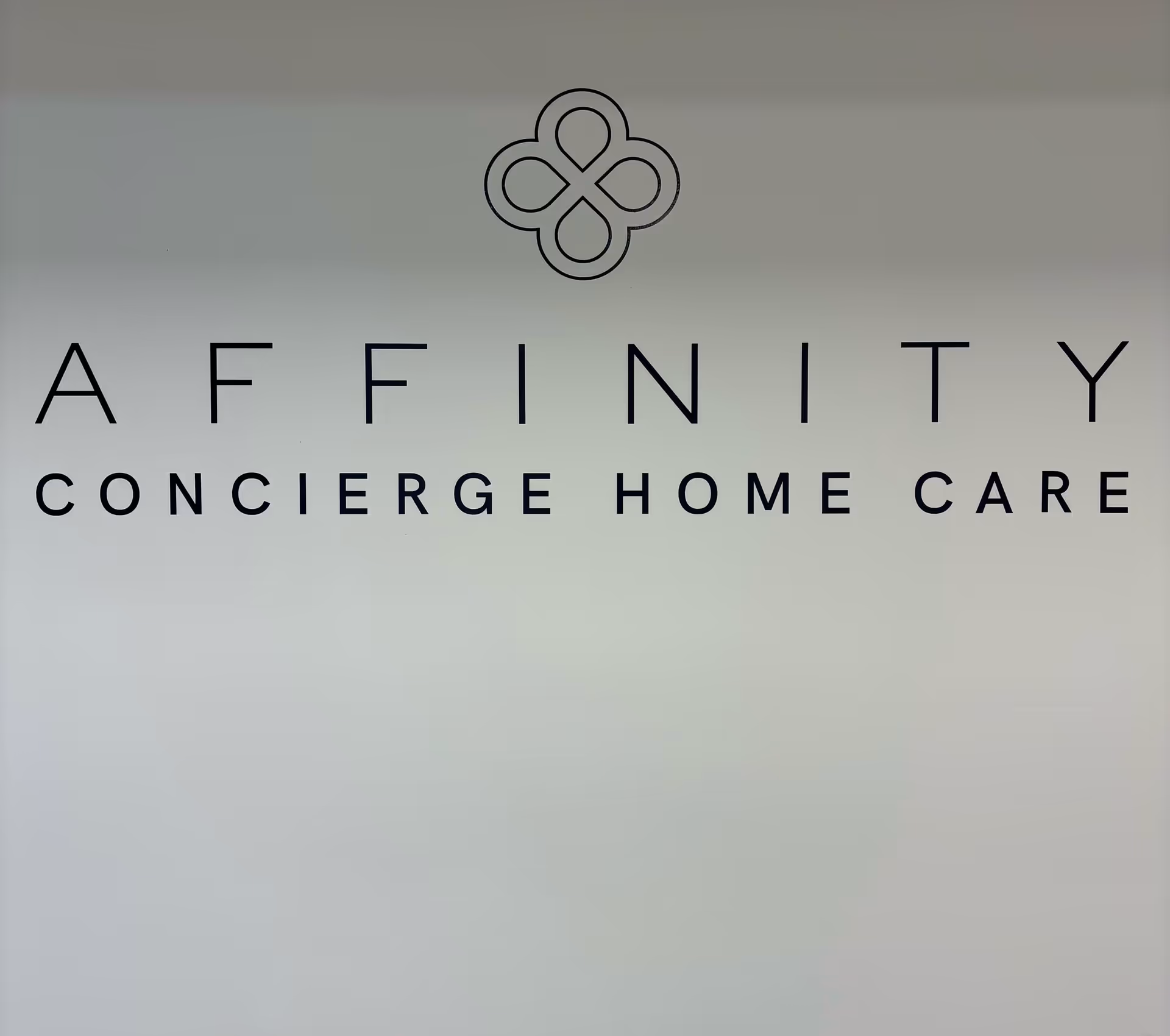 Affinity sign with logo reading Concierge Home Care on a light interior wall.
