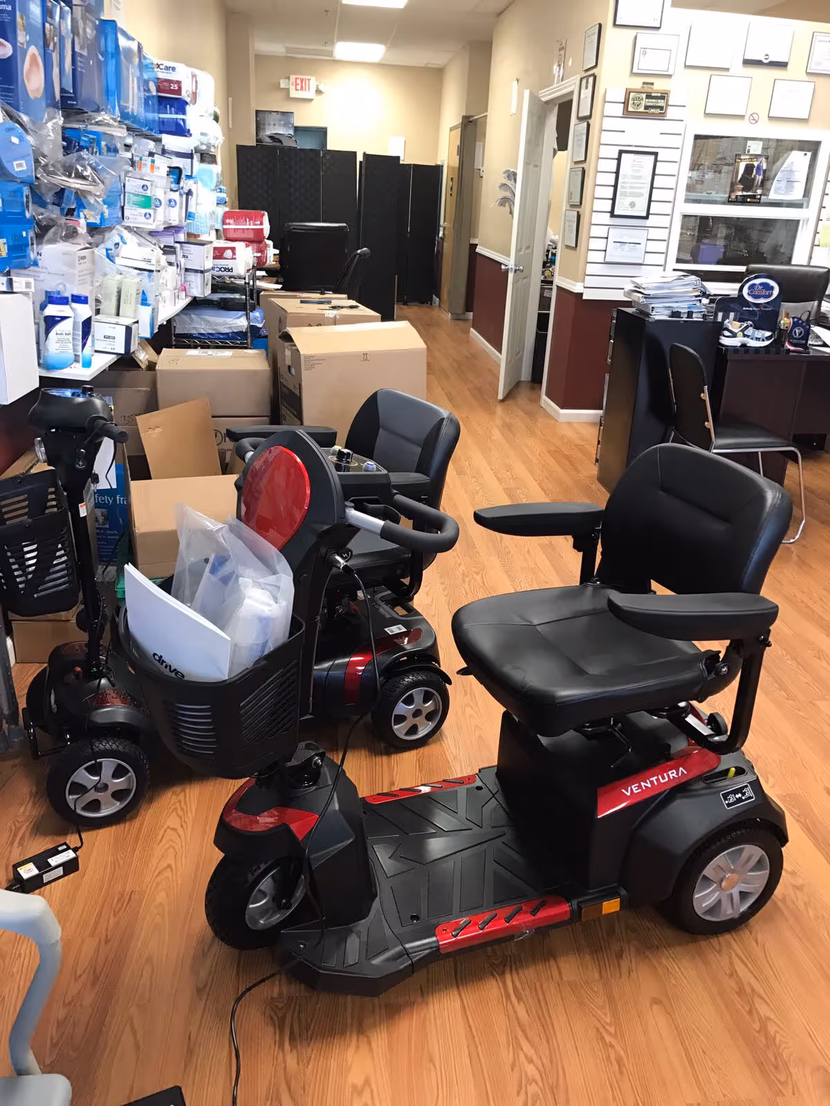 Interior storage area with mobility scooters, medical supplies, and stacked boxes.