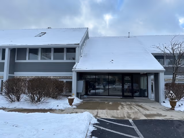 Snow blankets the entrance of a Comfort Keepers senior living facility.