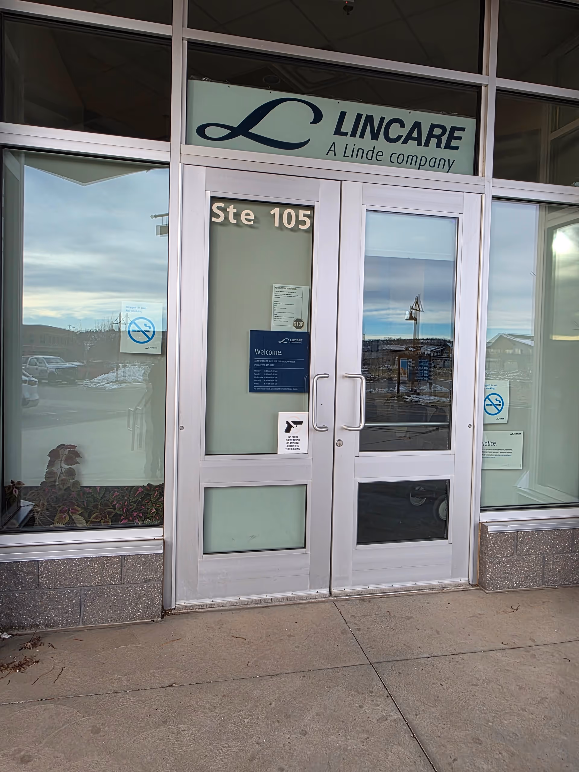 Glass entrance to LINCARE building with Ste 105 on door.
