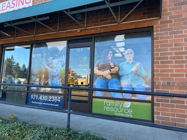 Brick storefront with large windows showing people and a Family Resource Home Care sign.