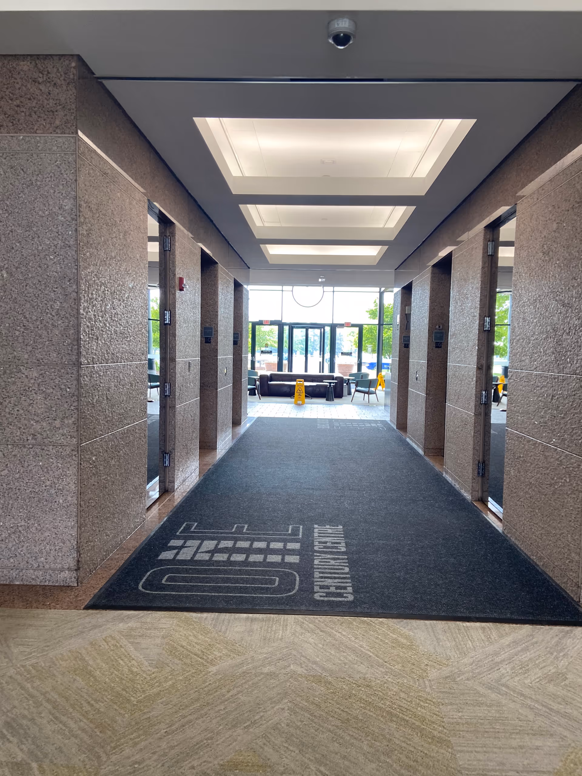 Long hallway inside Joyful Homecare Solution, LLC with a lounge area visible at the far end.