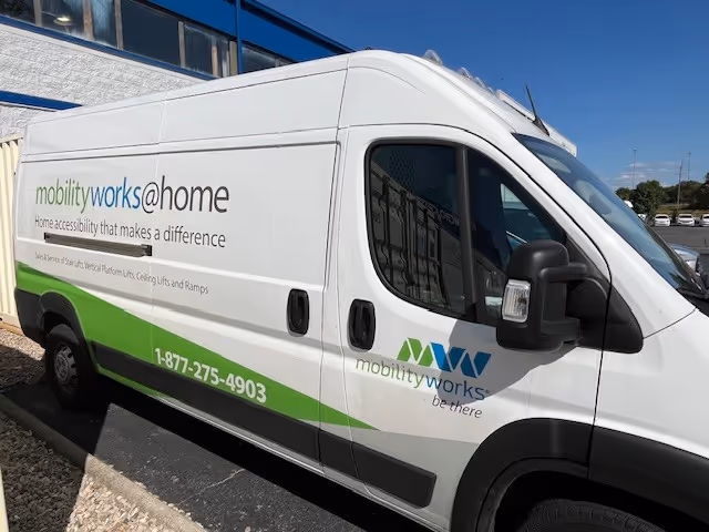 White MobilityWorks van with branding parked outside under blue sky.