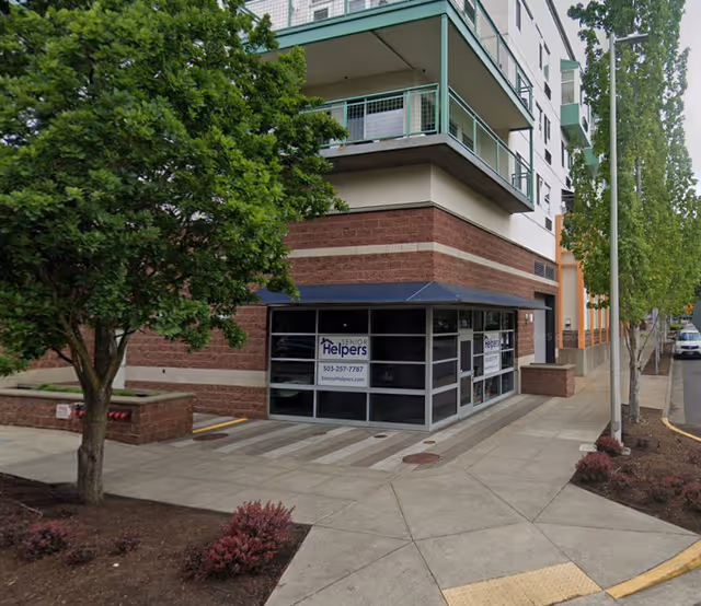Exterior view of a Senior Helpers facility with glass entrance and signage.