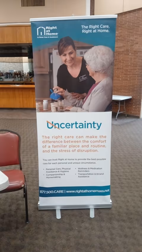 An indoor Right at Home banner showing a caregiver with an elderly woman.