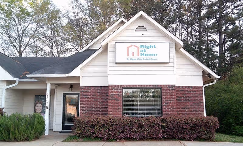 Front view of a Right at Home senior living facility with a sign.