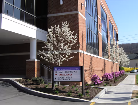 Exterior view of Wayne Memorial Hospital main entrance with trees and signage
