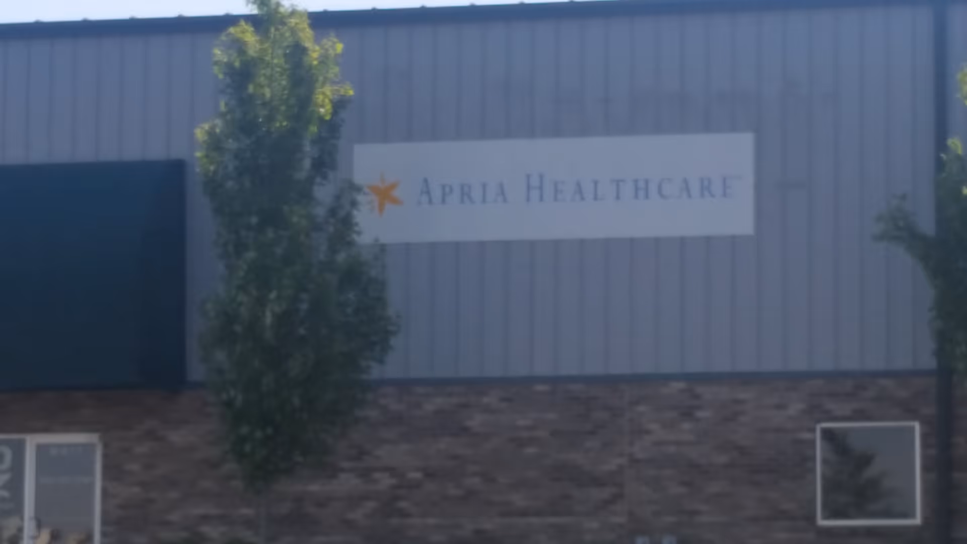 Exterior view of a facility with an Apria Healthcare sign on the building