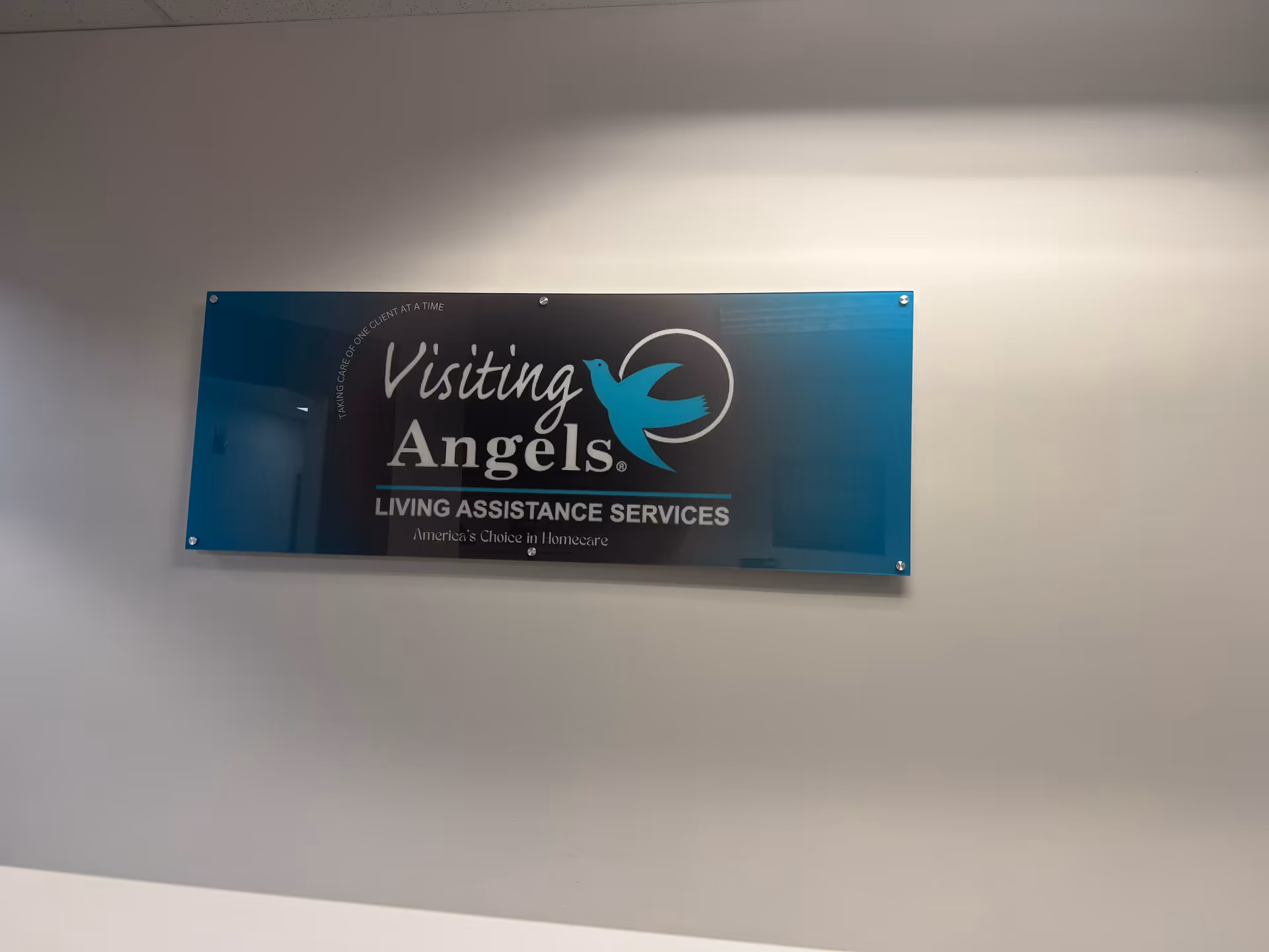 Interior wall with a blue sign displaying Visiting Angels Living Assistance Services.