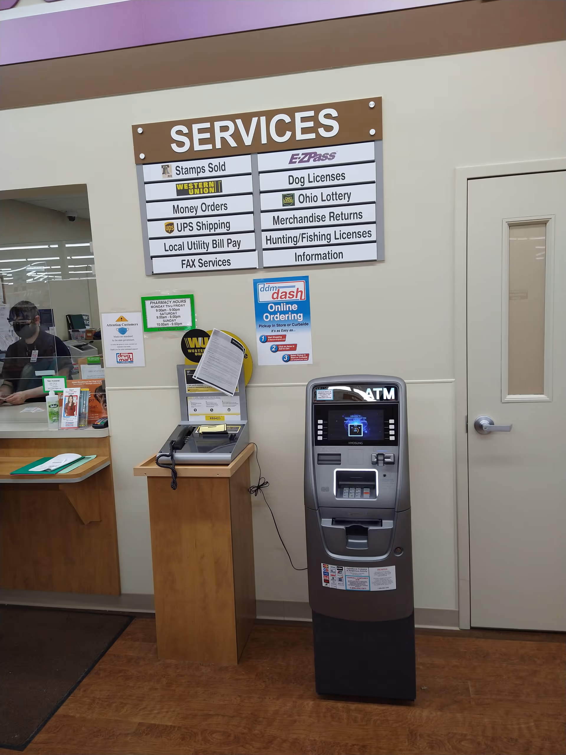 Inside Discount Drug Mart, a large SERVICES sign, a self-service kiosk, and an ATM are visible.