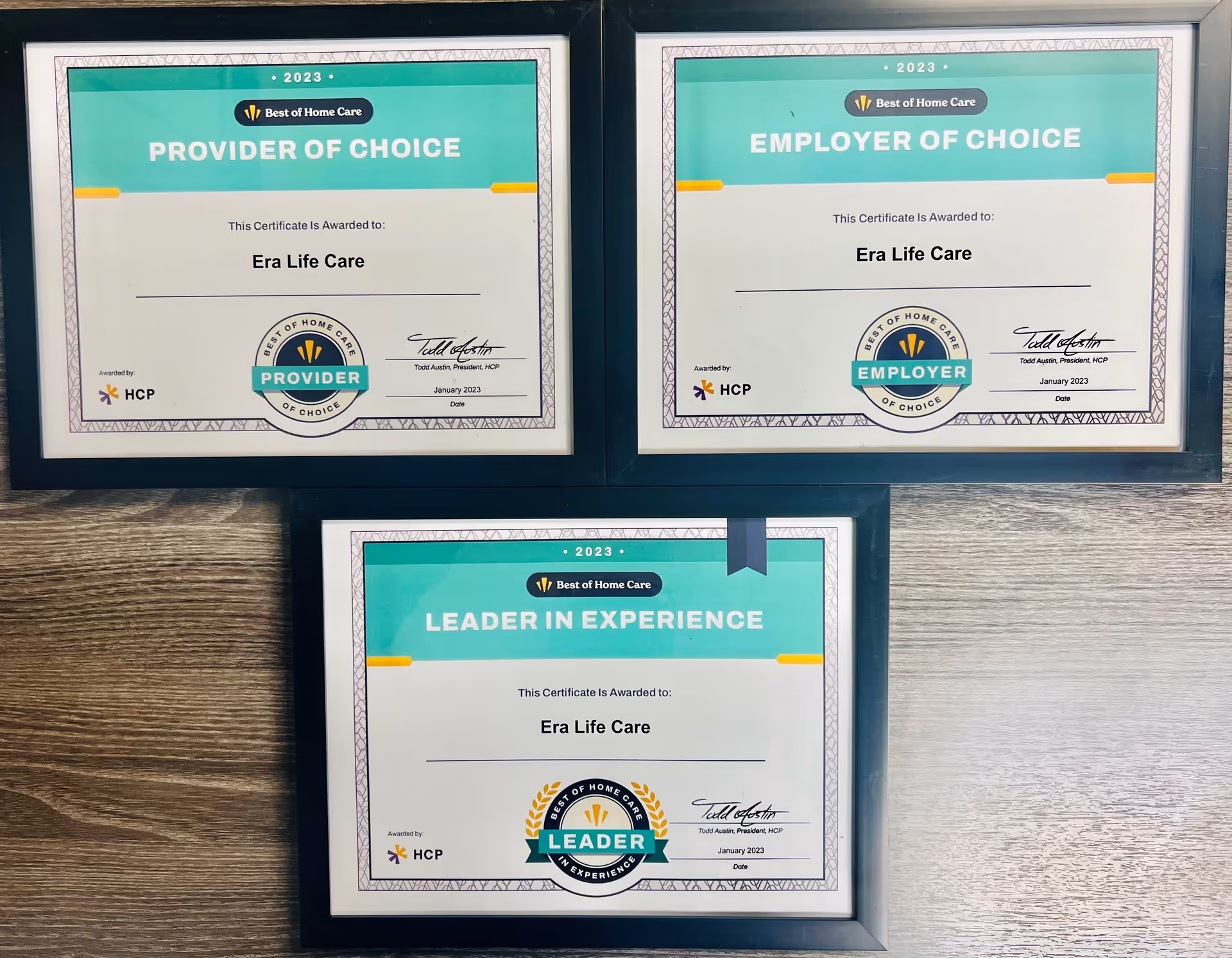 Three framed Best of Home Care certificates displayed on a wooden wall.