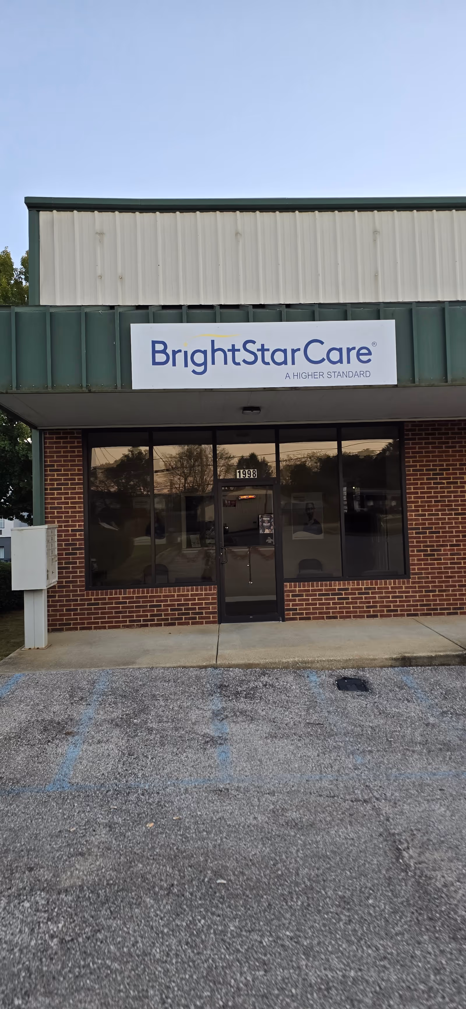 Front view of BrightStar Care facility sign on brick exterior with glass doors.