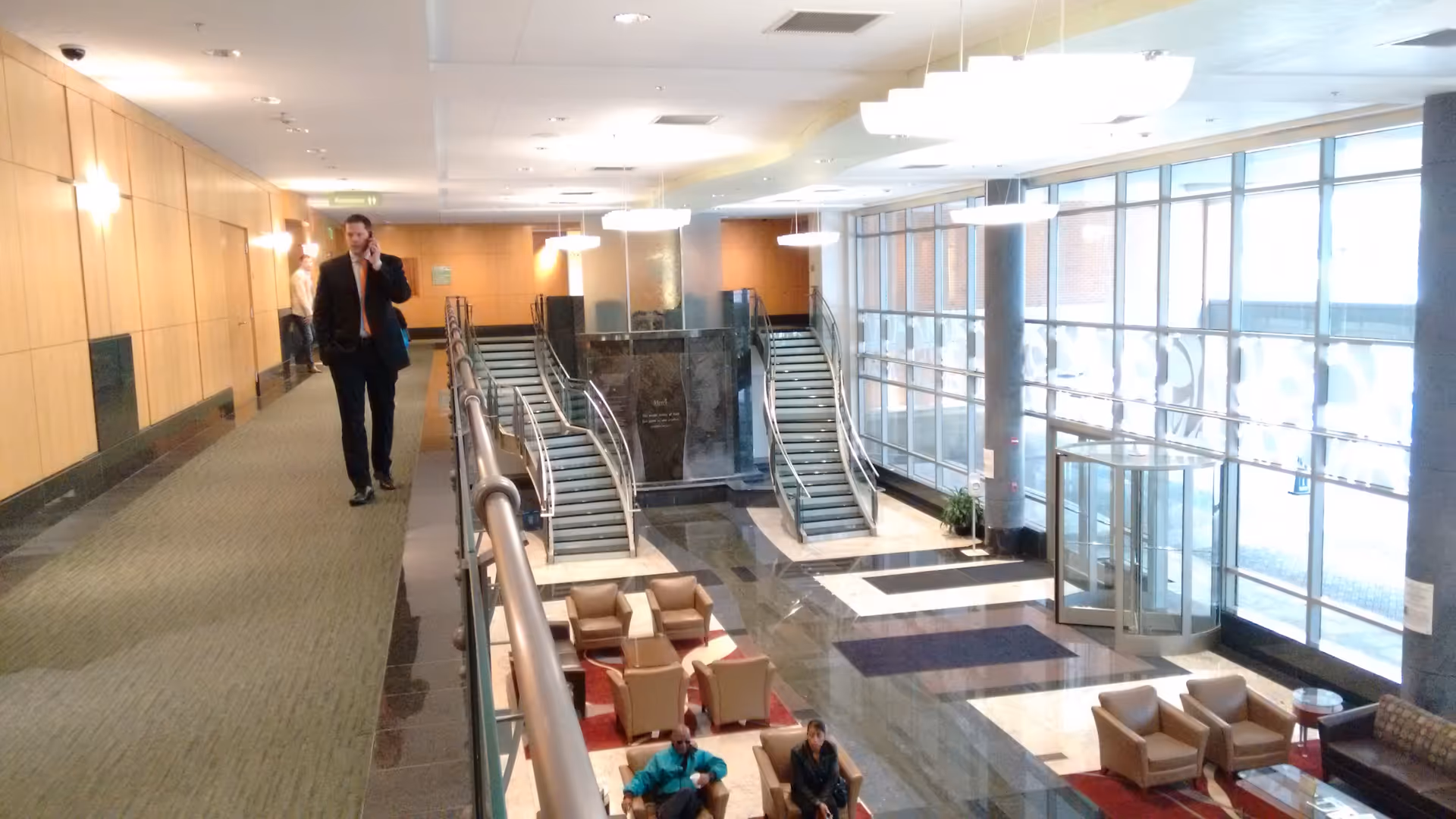 Spacious Mercy Medical Center lobby with escalators, glass walls, and seating areas.
