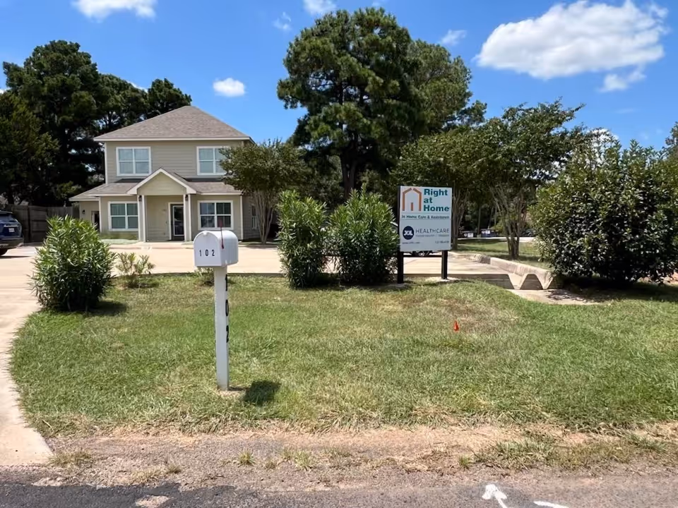 Exterior view of a Right at Home facility with sign and mailbox.