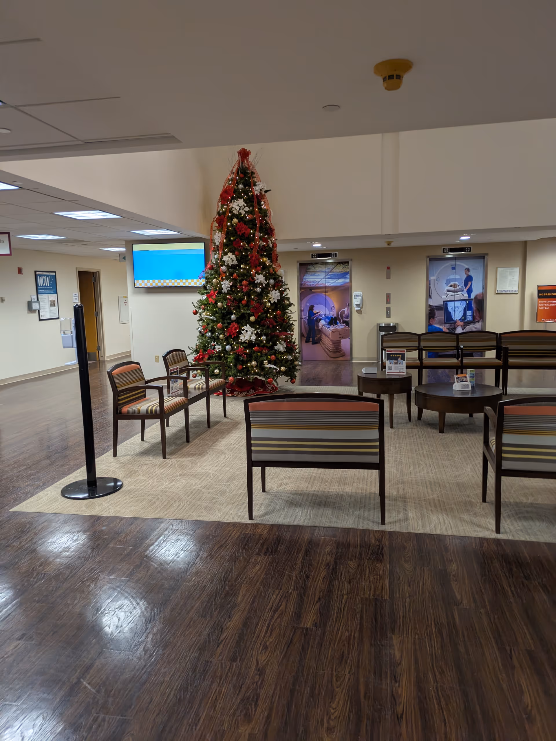 Interior of Lower Bucks Hospital lobby with a tall Christmas tree and seating.