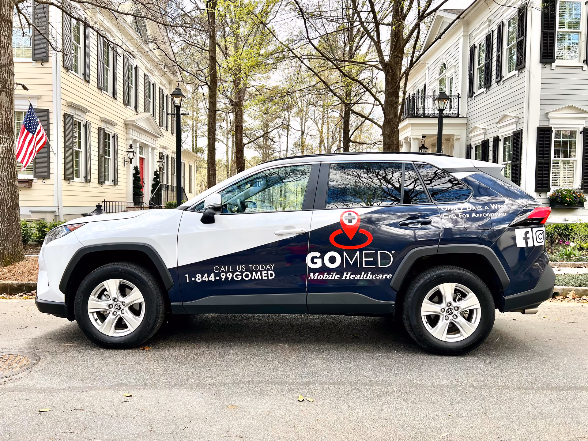 GOMED Mobile Healthcare SUV parked on a residential street with houses and trees