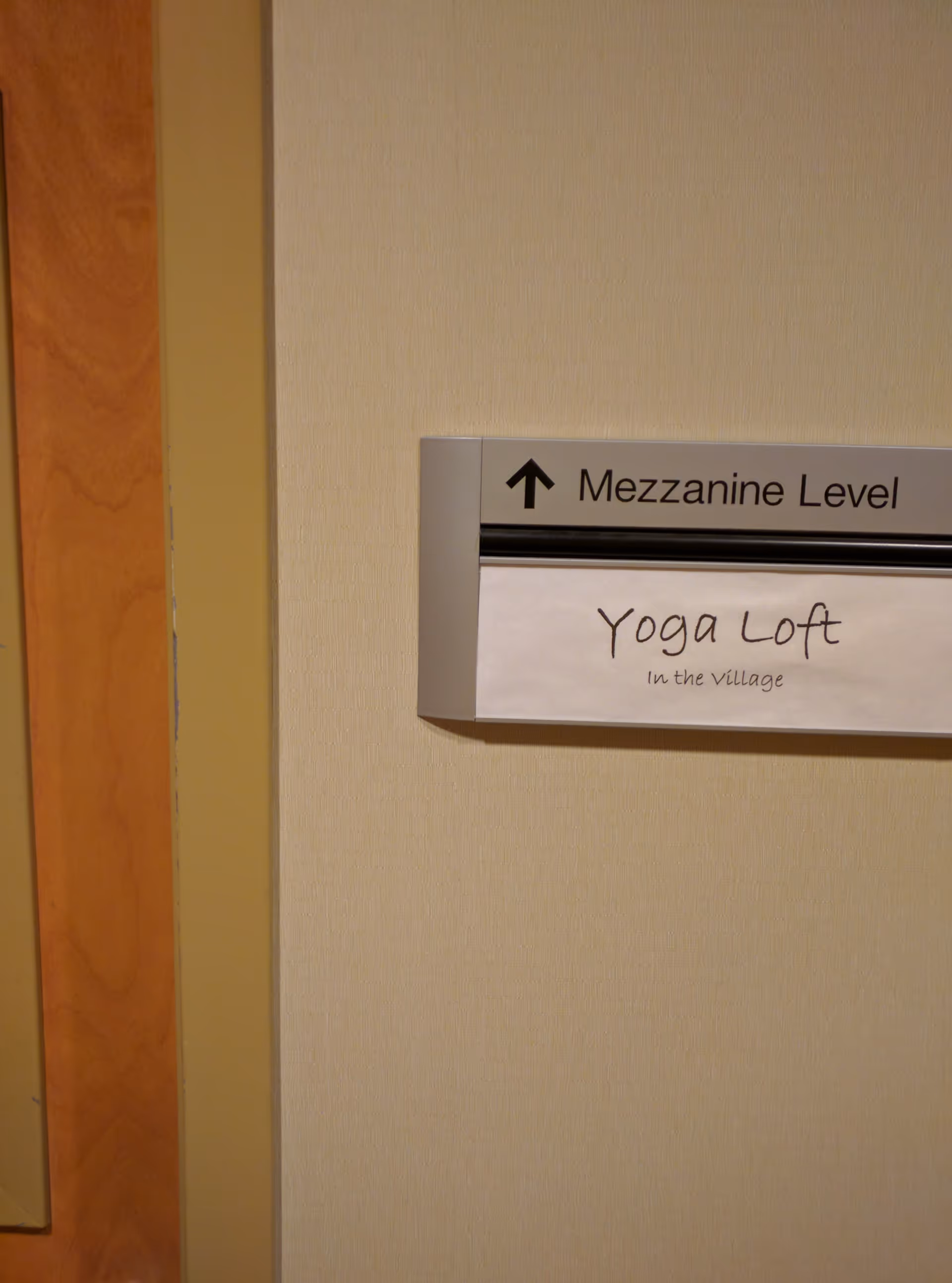Interior hallway with mezzanine level sign and Yoga Loft plaque