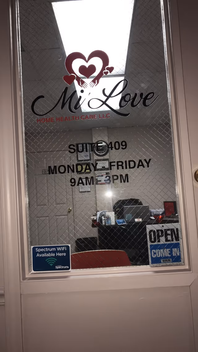 Glass door displays Mi Love Home Health Care logo, suite 409, with open sign.