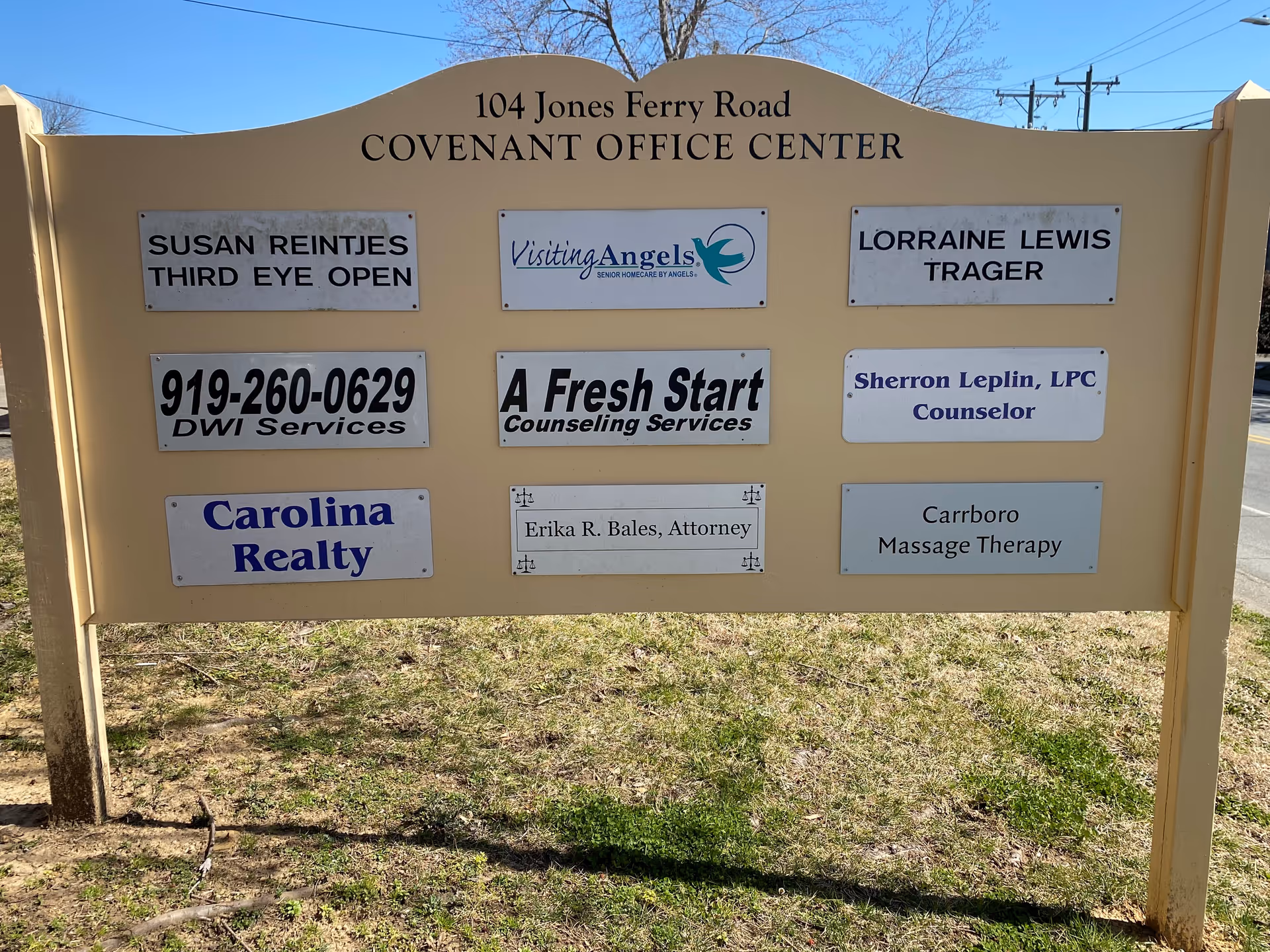 Exterior signboard displays multiple business plaques, including Visiting Angels, at Covenant Office Center.