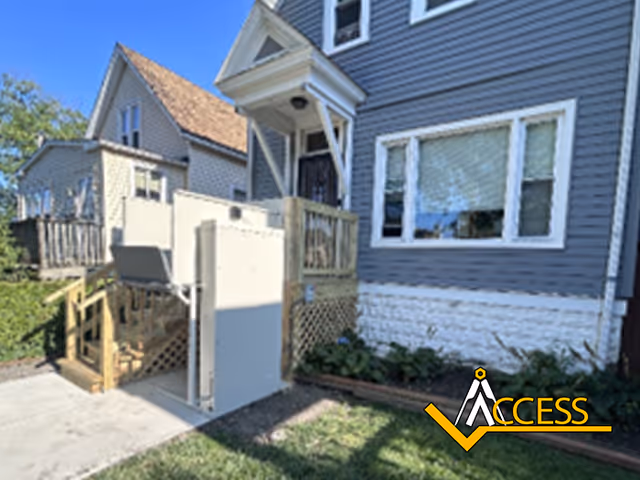 Front exterior of a house with an outside accessibility ramp and lift.