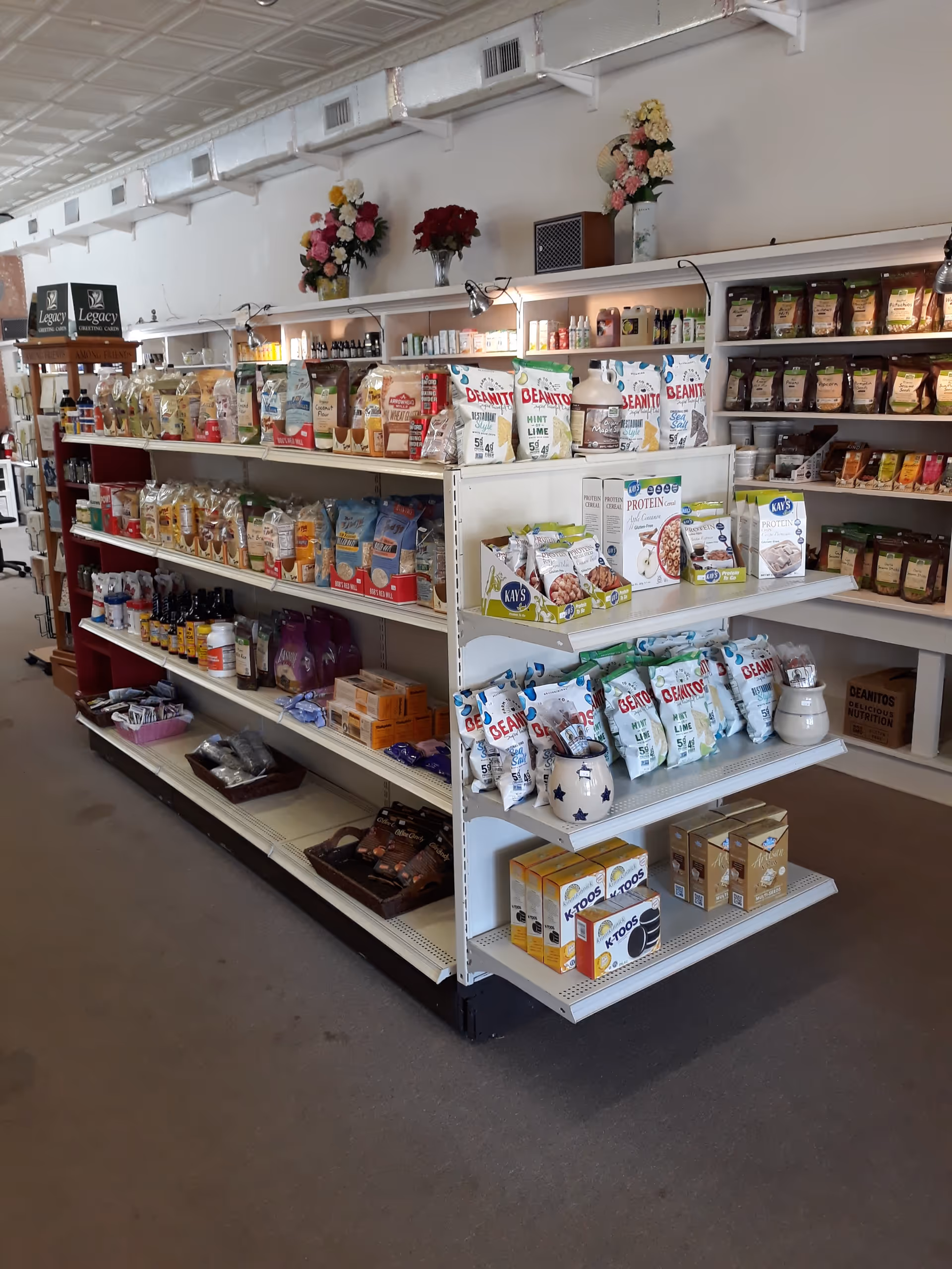 Inside a senior living facility store, shelves stocked with snacks, supplements, and essentials.