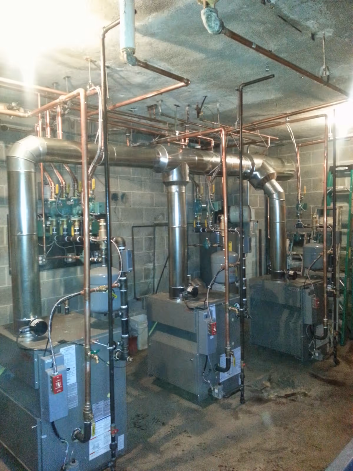 Industrial boiler room with metal pipes and exposed plumbing.