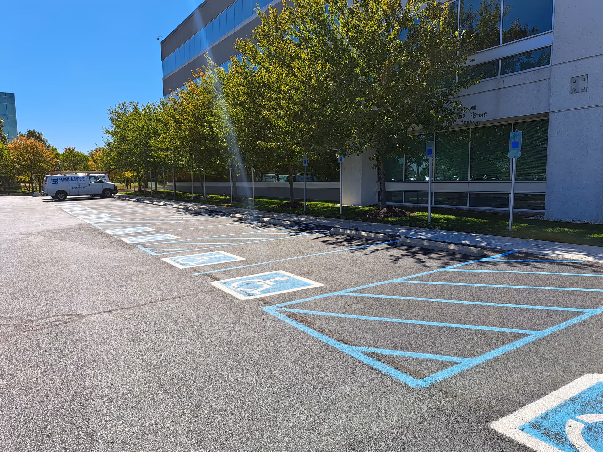 Parking lot in front of a modern building with a St. Croix Hospice van.