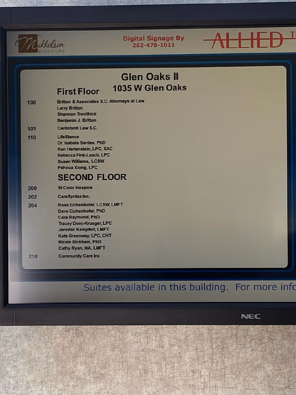 Indoor building directory sign listing floor suites and tenants.