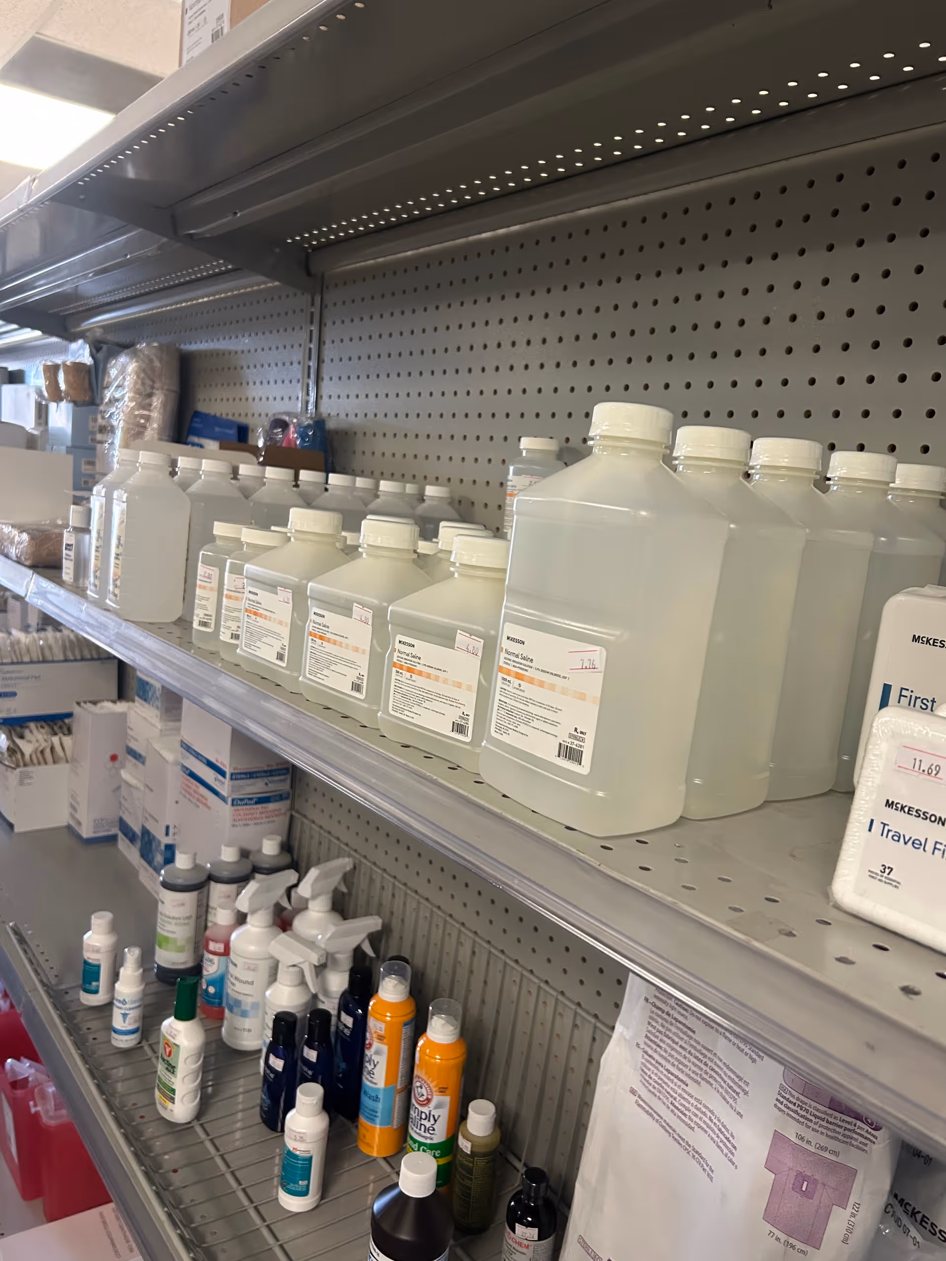 Interior supply shelf in a care facility stocked with medical bottles.