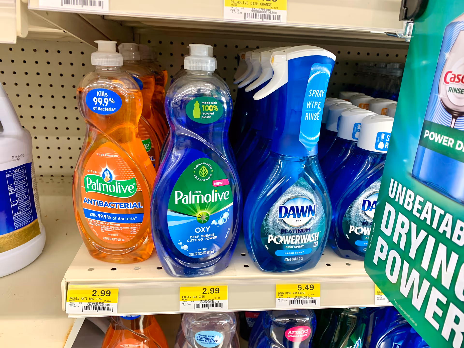 Store shelf displaying Palmolive and Dawn dish soap among cleaners at Discount Drug Mart