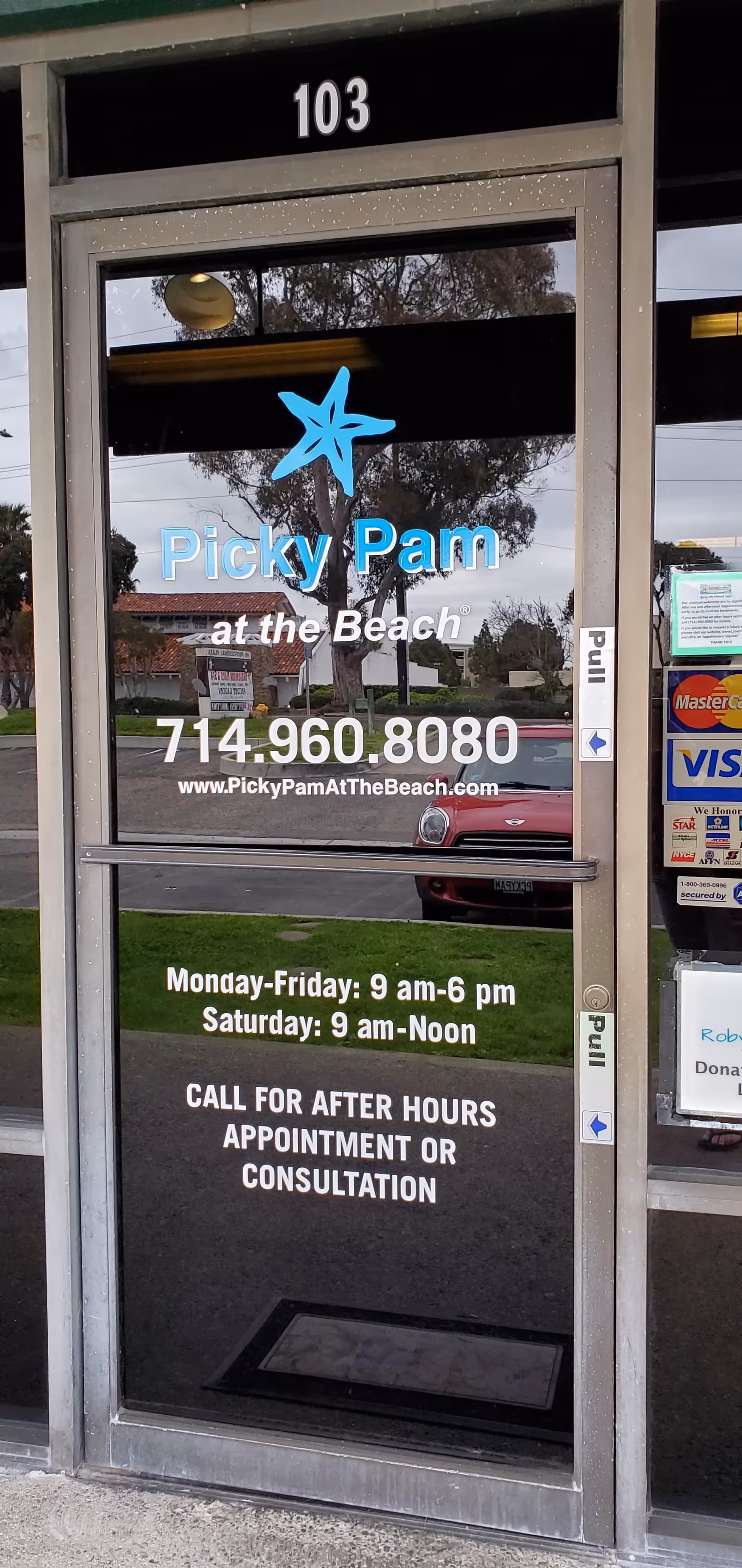 Glass storefront door with Picky Pam at the Beach logo and hours