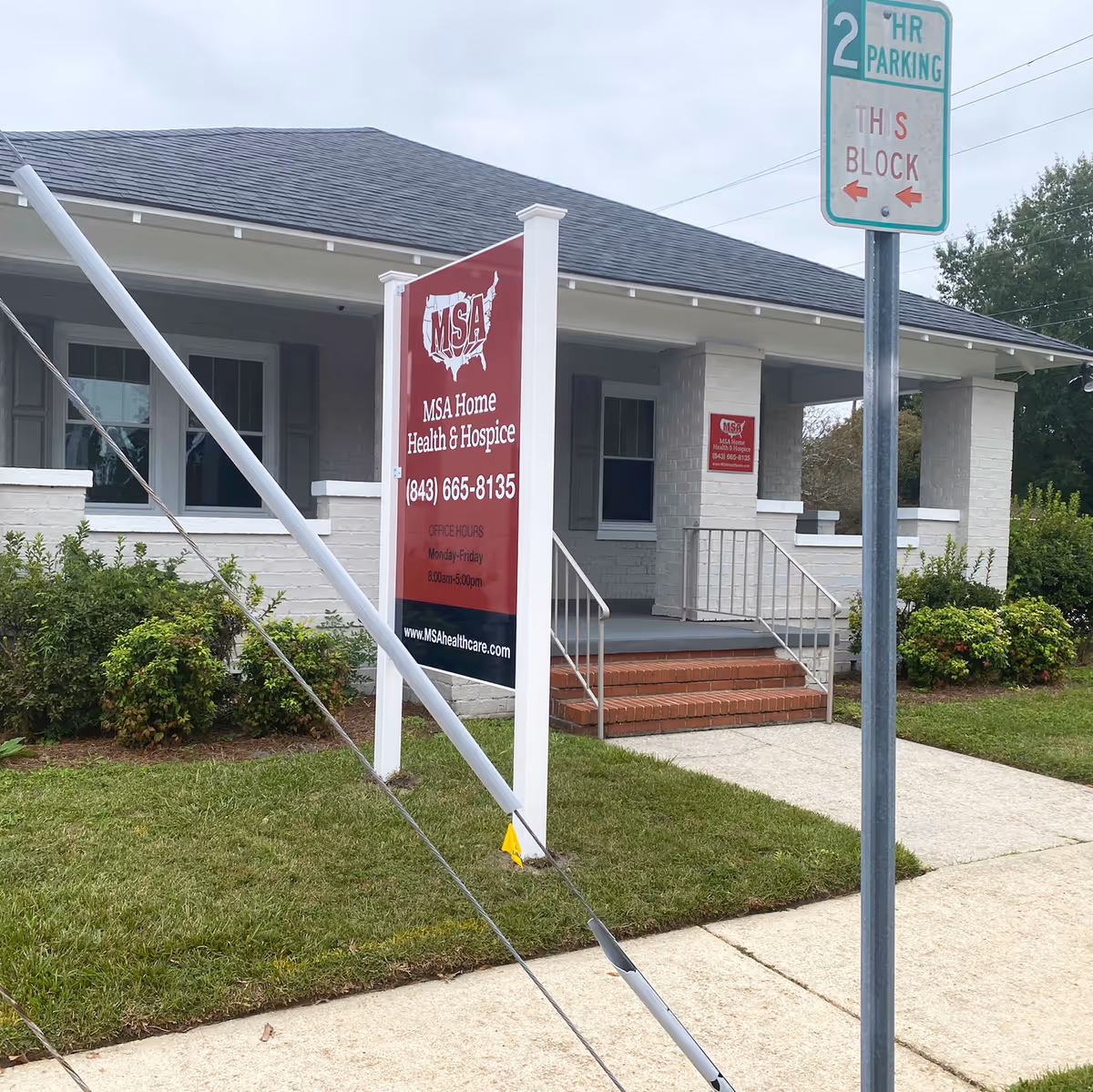 Front view of a hospice building with a large red MSA sign and entrance steps.