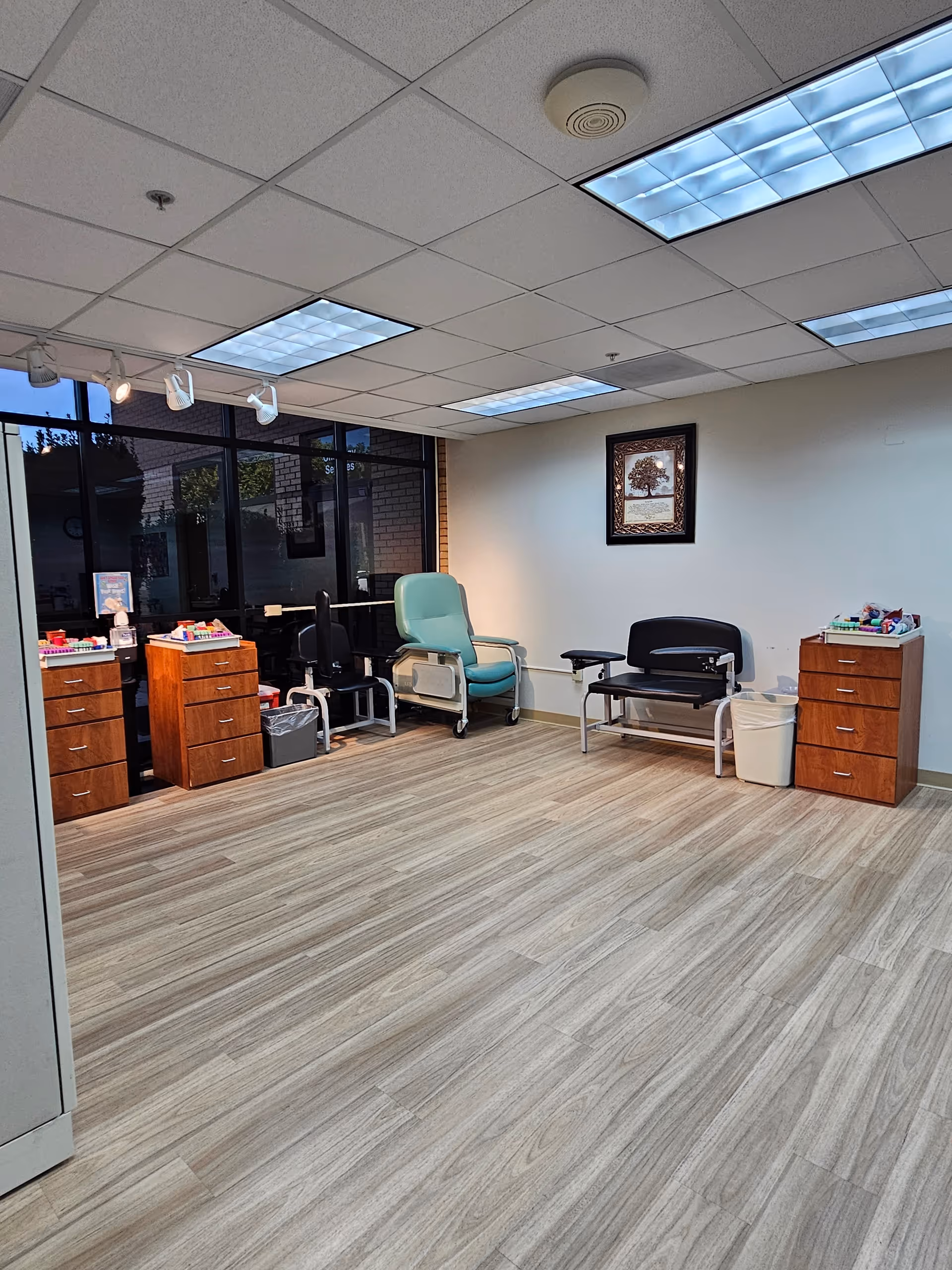 Interior medical treatment room at MUSC Health Kershaw Medical Center with chairs and cabinets.