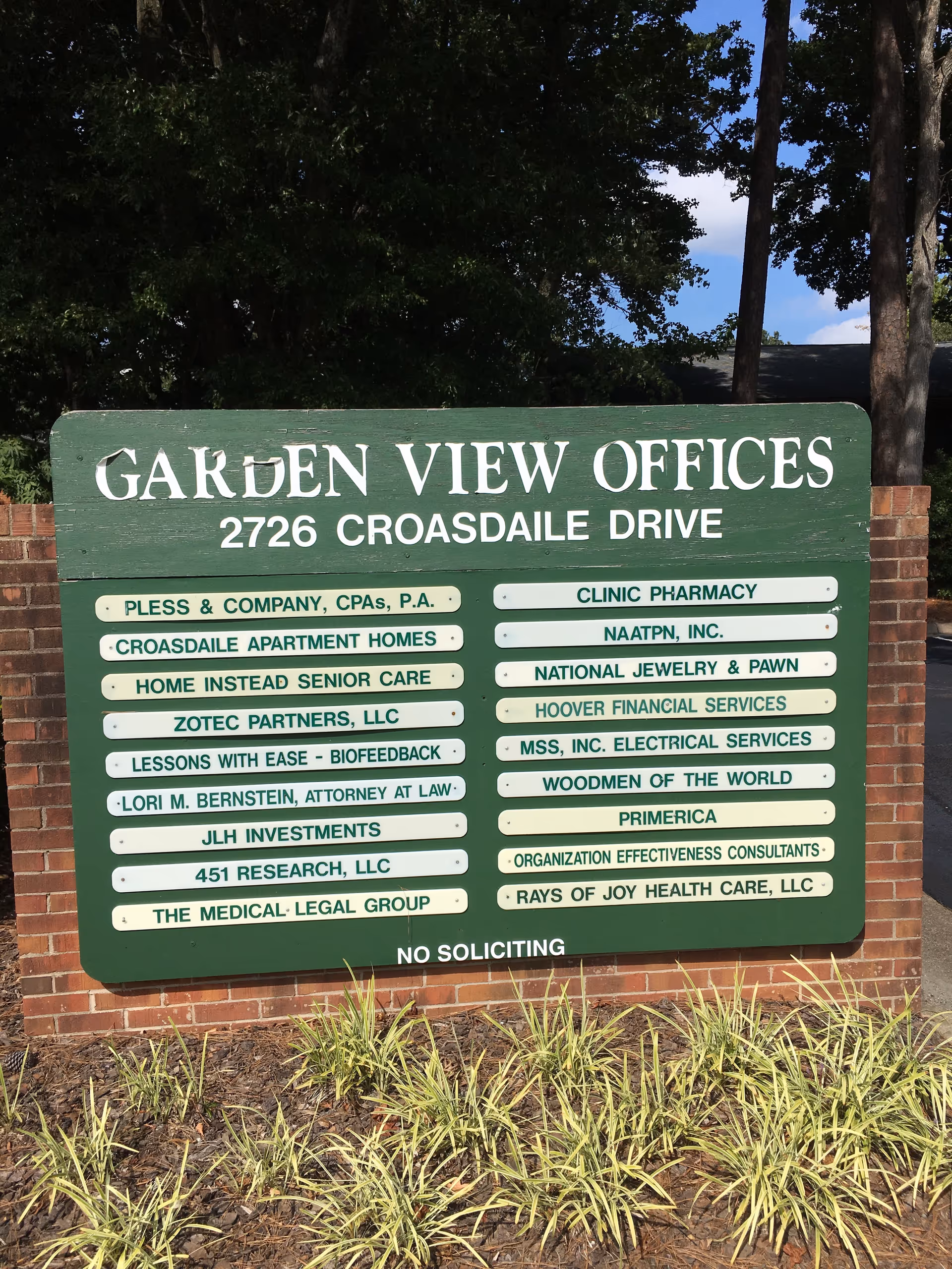 Large green signboard for Garden View Offices with 2726 Crossdale Drive in front of brick wall