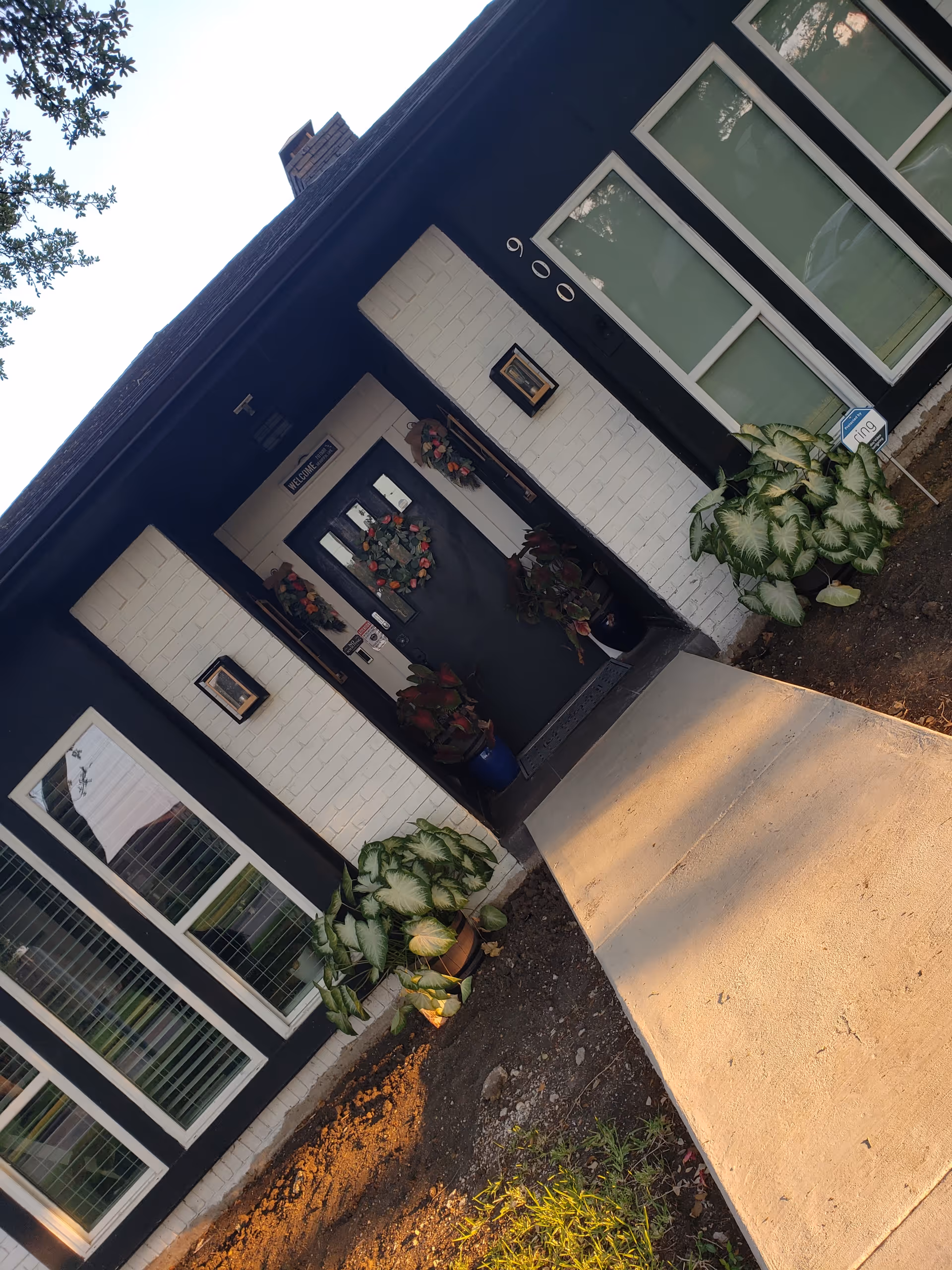 Entrance to Integrity Residential Care building with wreaths, potted plants, and dark exterior.